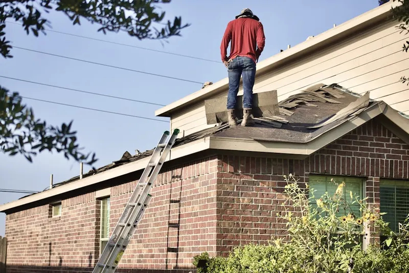 Professional roofer working on a residential roof in Oasis